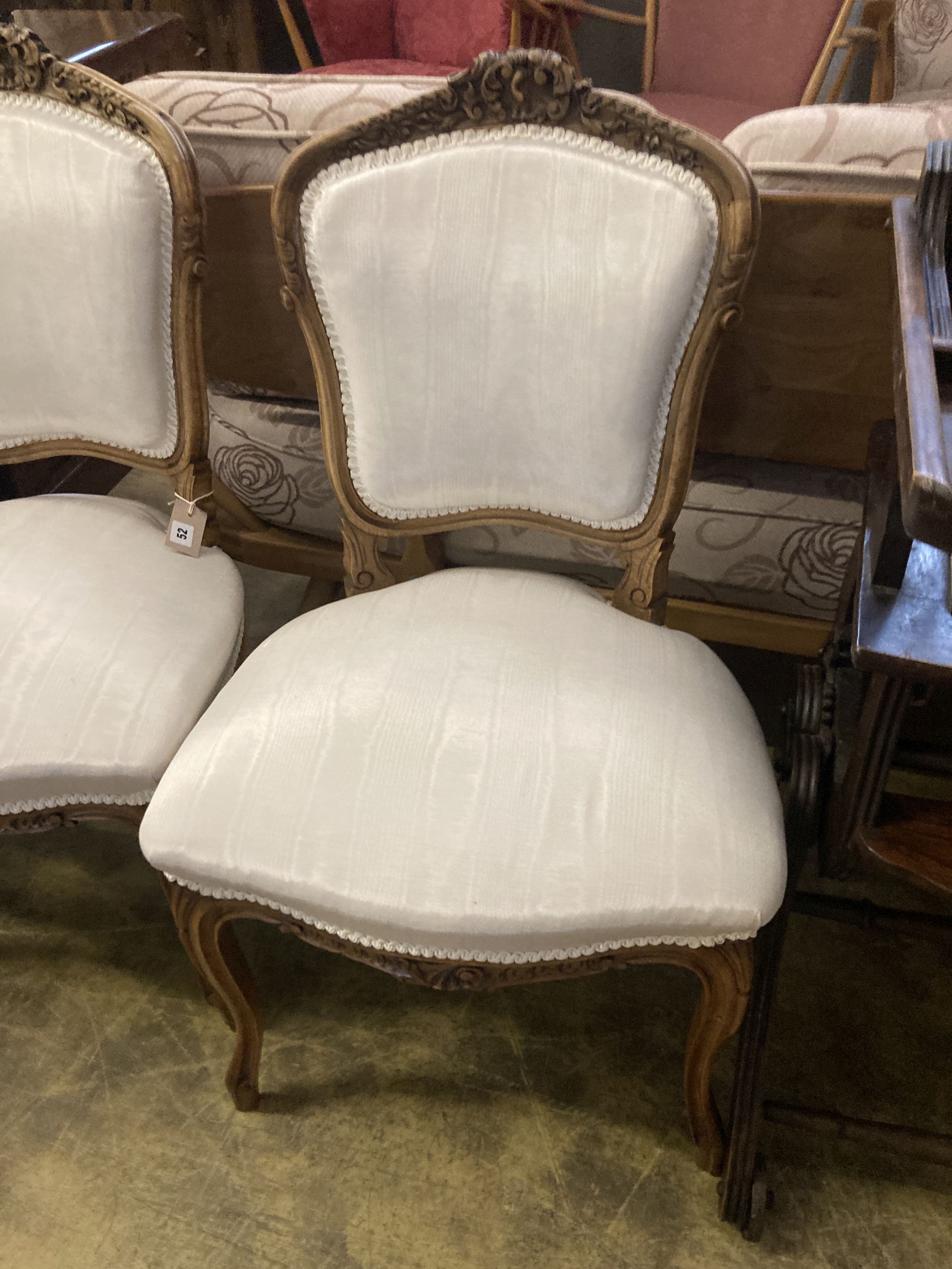 A pair of Louis XV style carved walnut side chairs